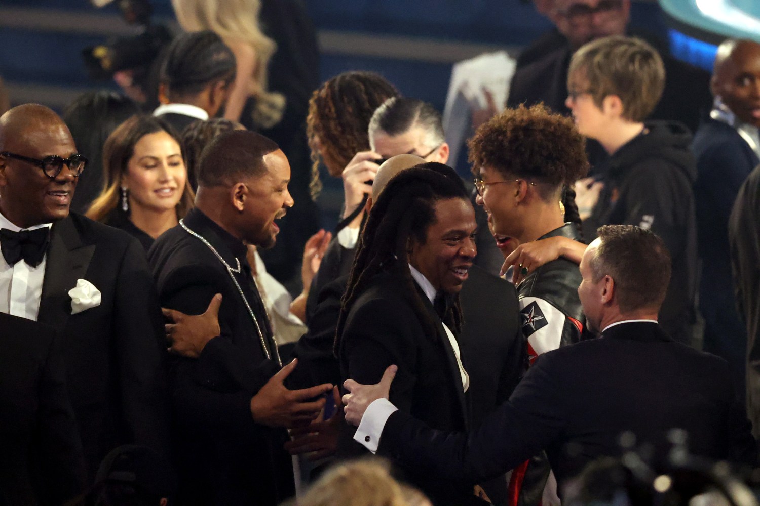 Will Smith is pictured standing behind Jay Z at the Grammy Awards.