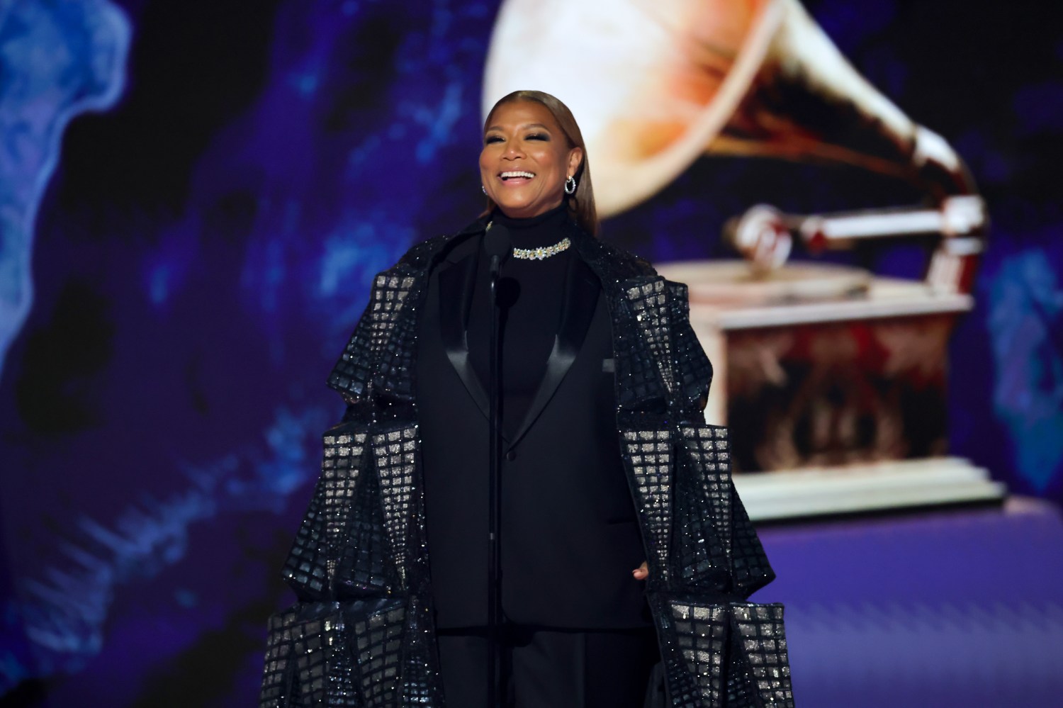 Queen Latifah stands on stage during the Grammy Awards.