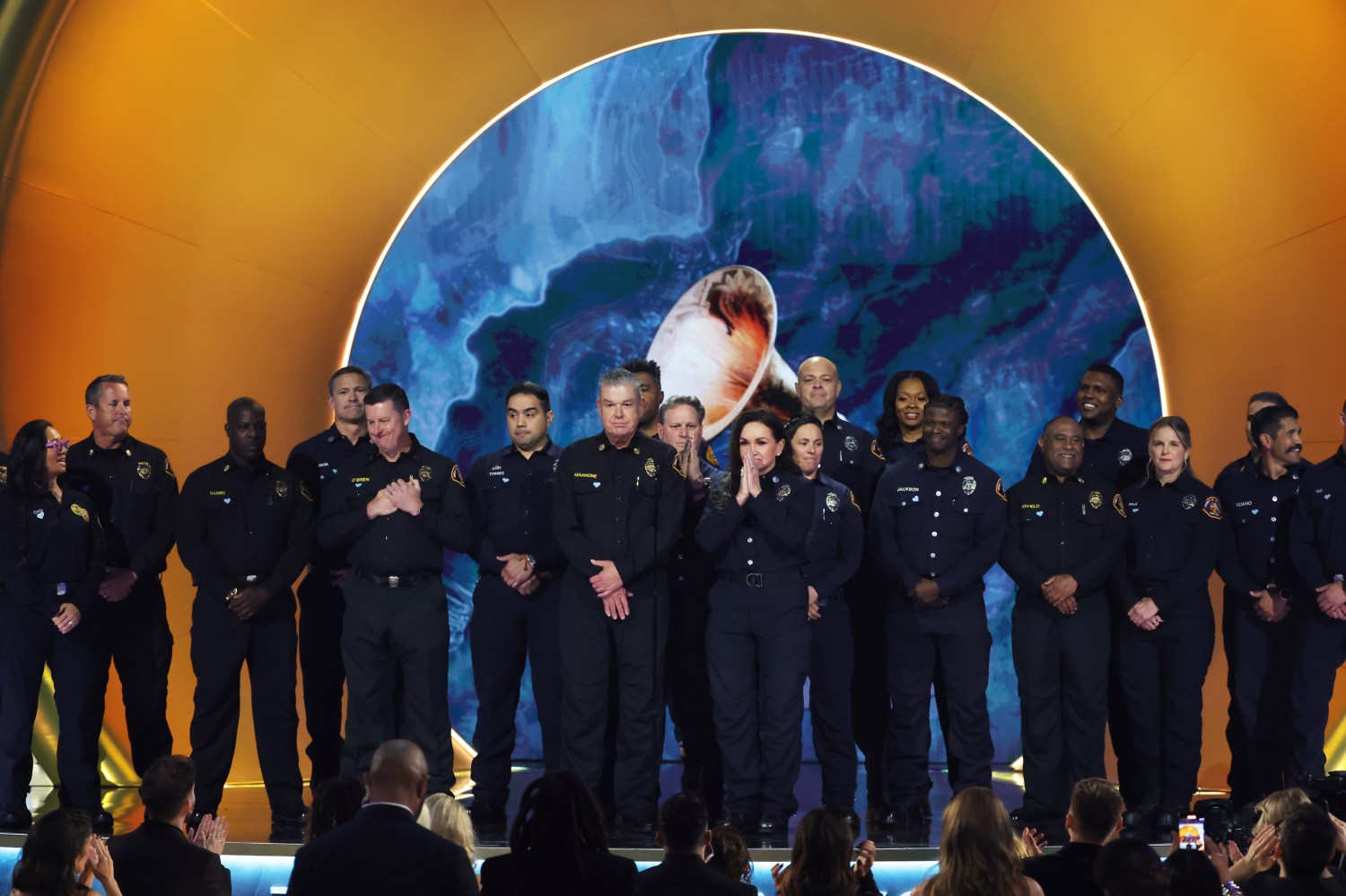 Los Angeles County Fire Department members appear during the Grammy Awards.