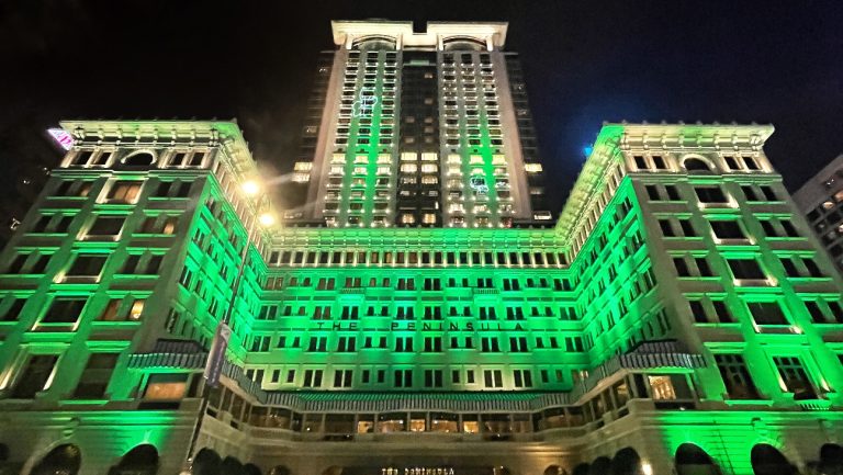 The-Peninsula-Hong-Kongs-elegant-faade-will-be-bathed-in-vibrant-green-light-in-the-shape-of-threel.jpeg